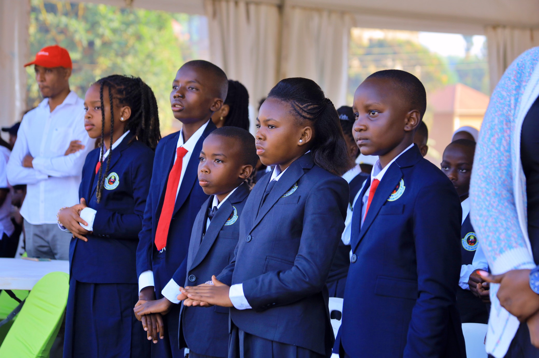 Pamville prefects in navy school uniforms standing together at the leadership ceremony