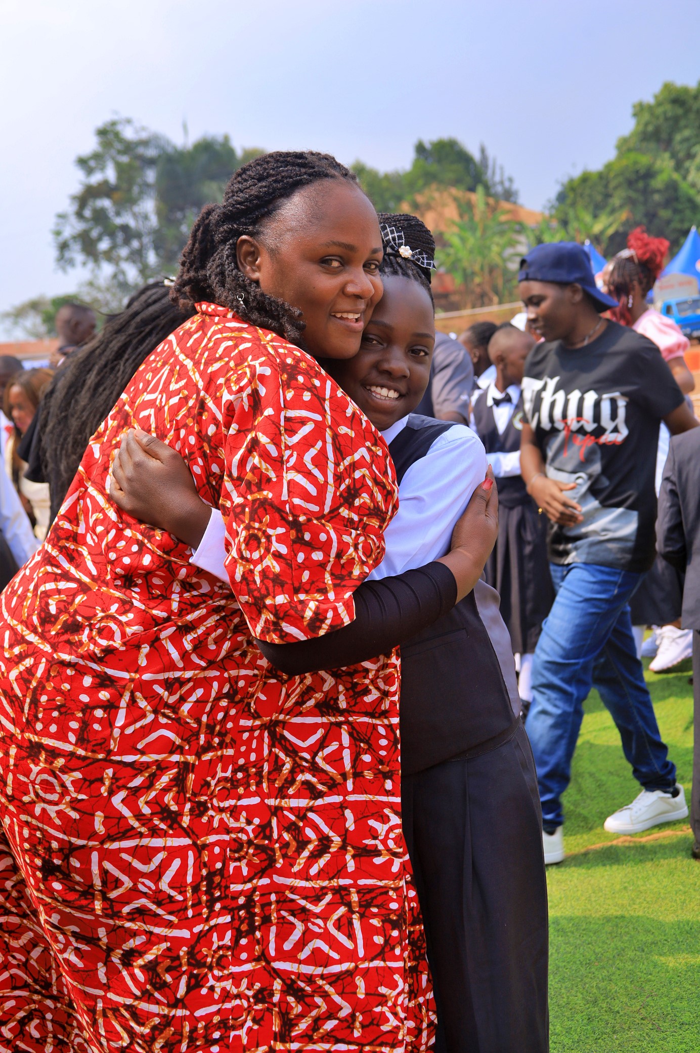 A Pamville mother embracing her daughter at a school community event