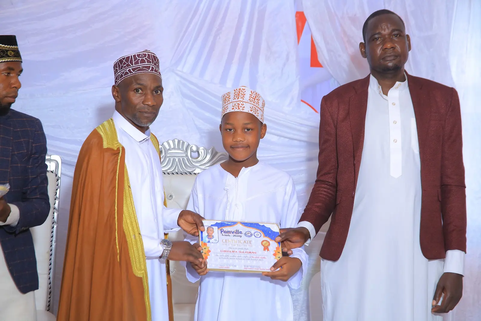 Pamville learner receiving an academic achievement certificate