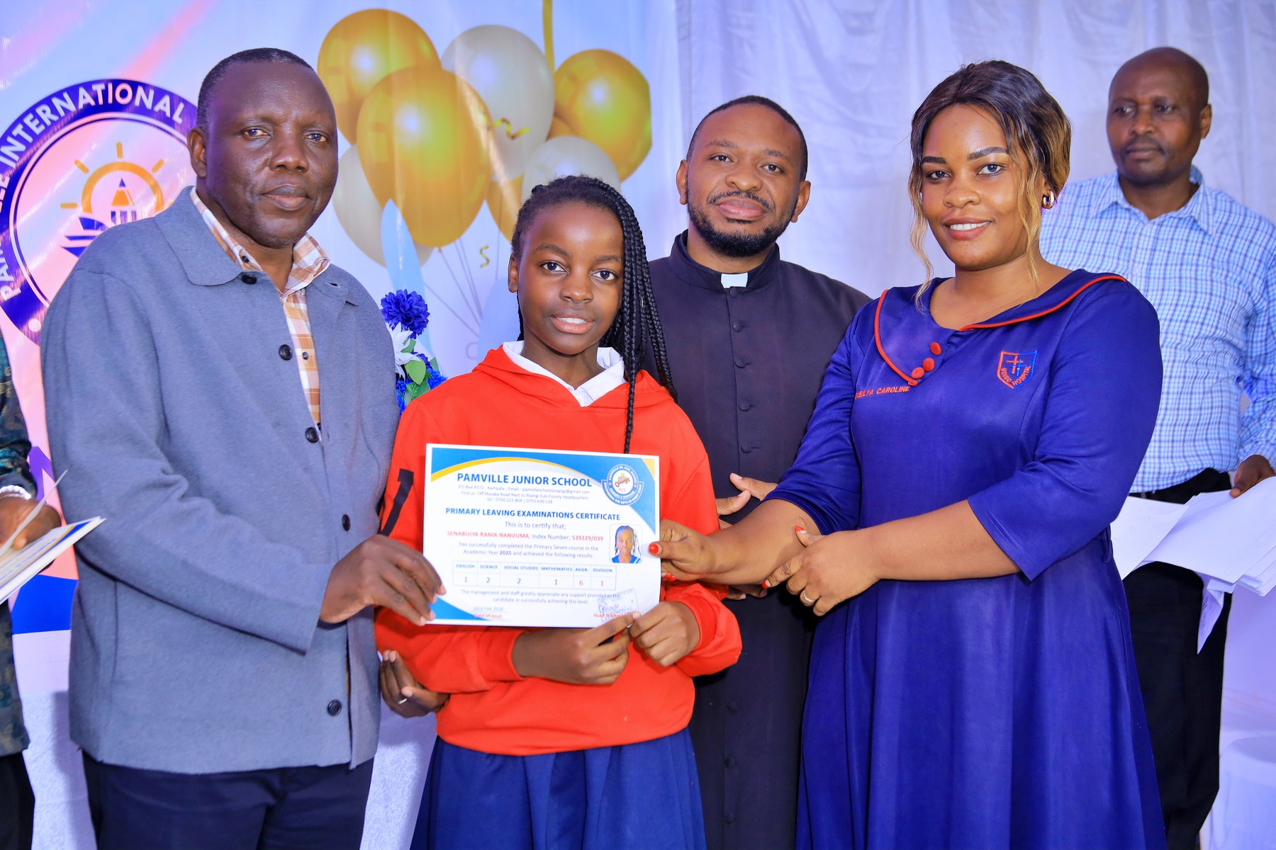 Pamville learner proudly receiving a Primary Leaving Examinations certificate