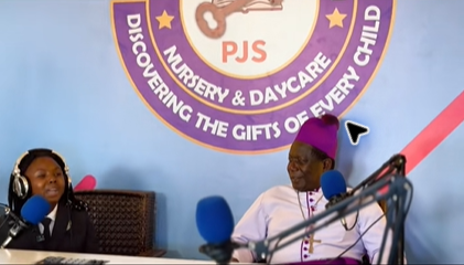 Rev. Moses Banja speaking with a guest in Pamville Studios